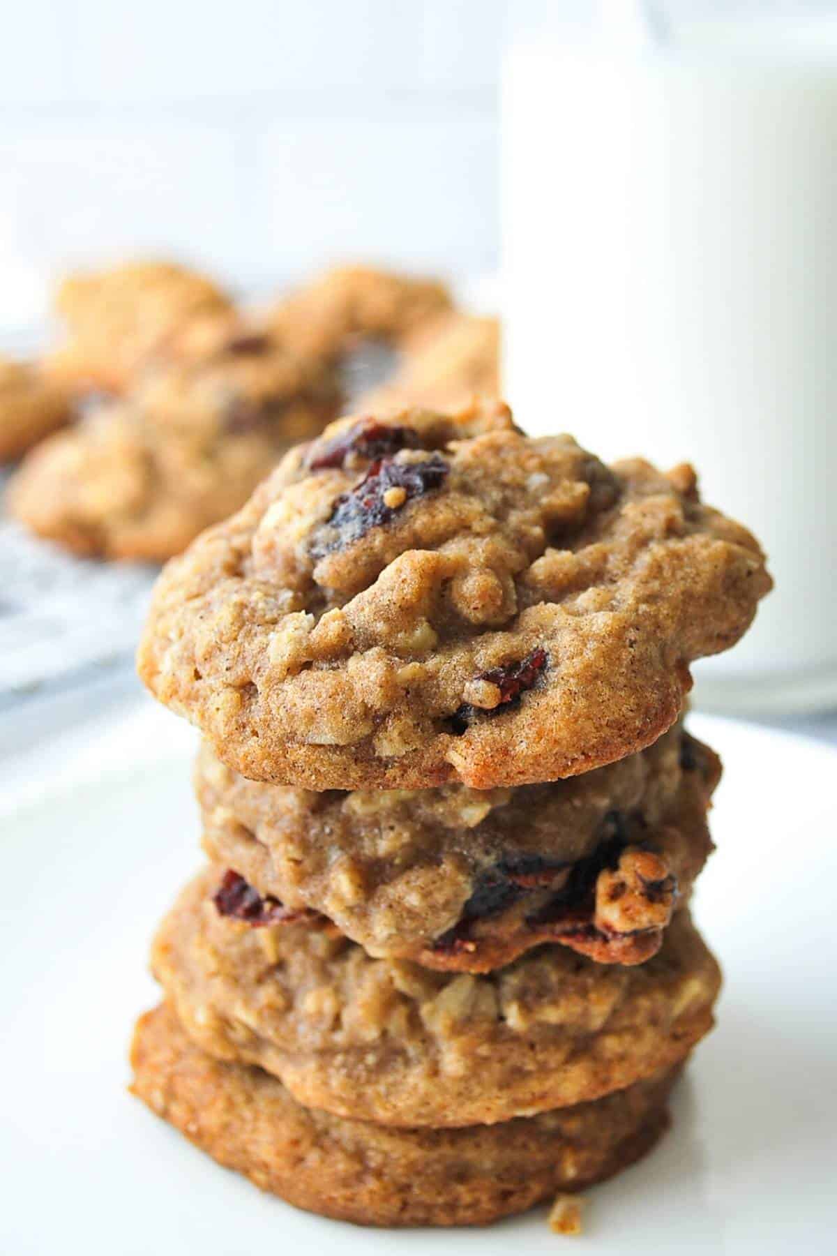 stack of gluten-free cranberry oatmeal cookies with milk