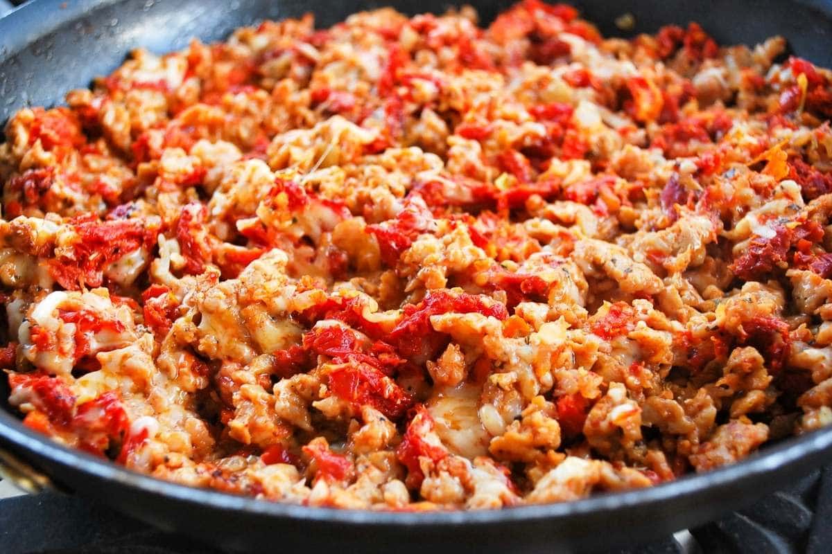 cooking filling for Italian stuffed mushrooms in a large skillet