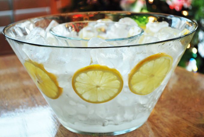 clear bowl full of ice and lemons for serving shrimp cocktail