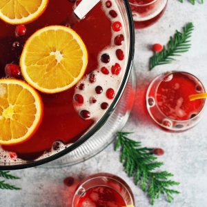 overhead photo of punch bowl with orange slices and cranberries