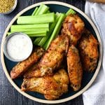 overhead photo of a plate of lemon pepper chicken wings with ranch and celery