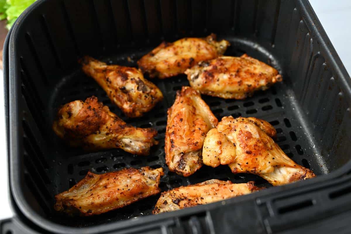 cooked wings in an air fryer basket