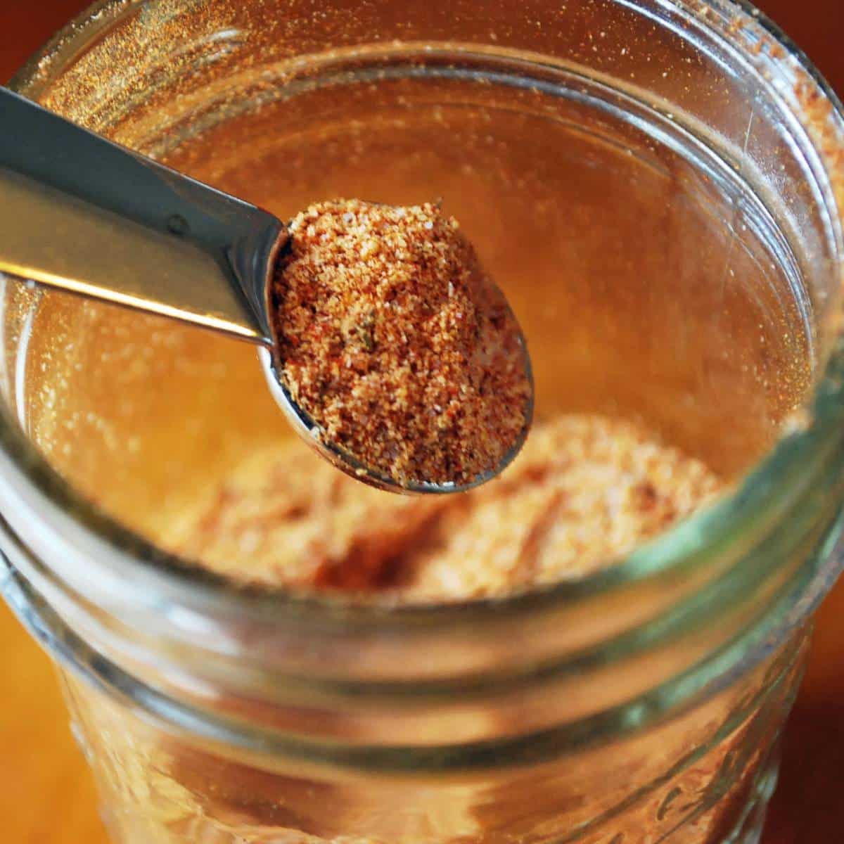 a teaspoon scooping out seasoned salt in a mason jar