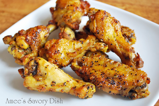 Close up of cooked chicken wings covered in lemon pepper on a plate