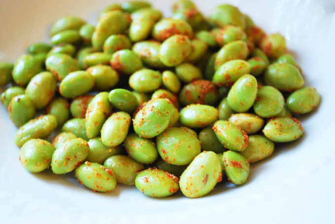A close up of Edamame with seasoning