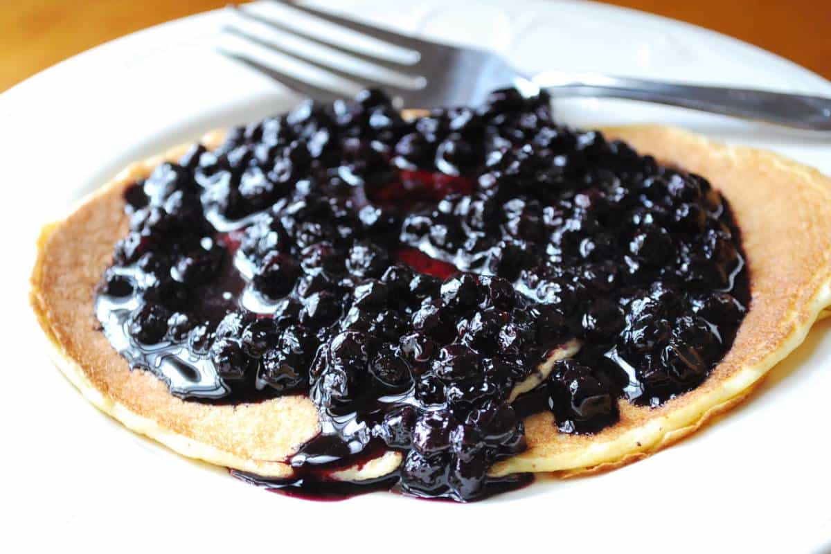 blueberry compote on a pancake with a fork