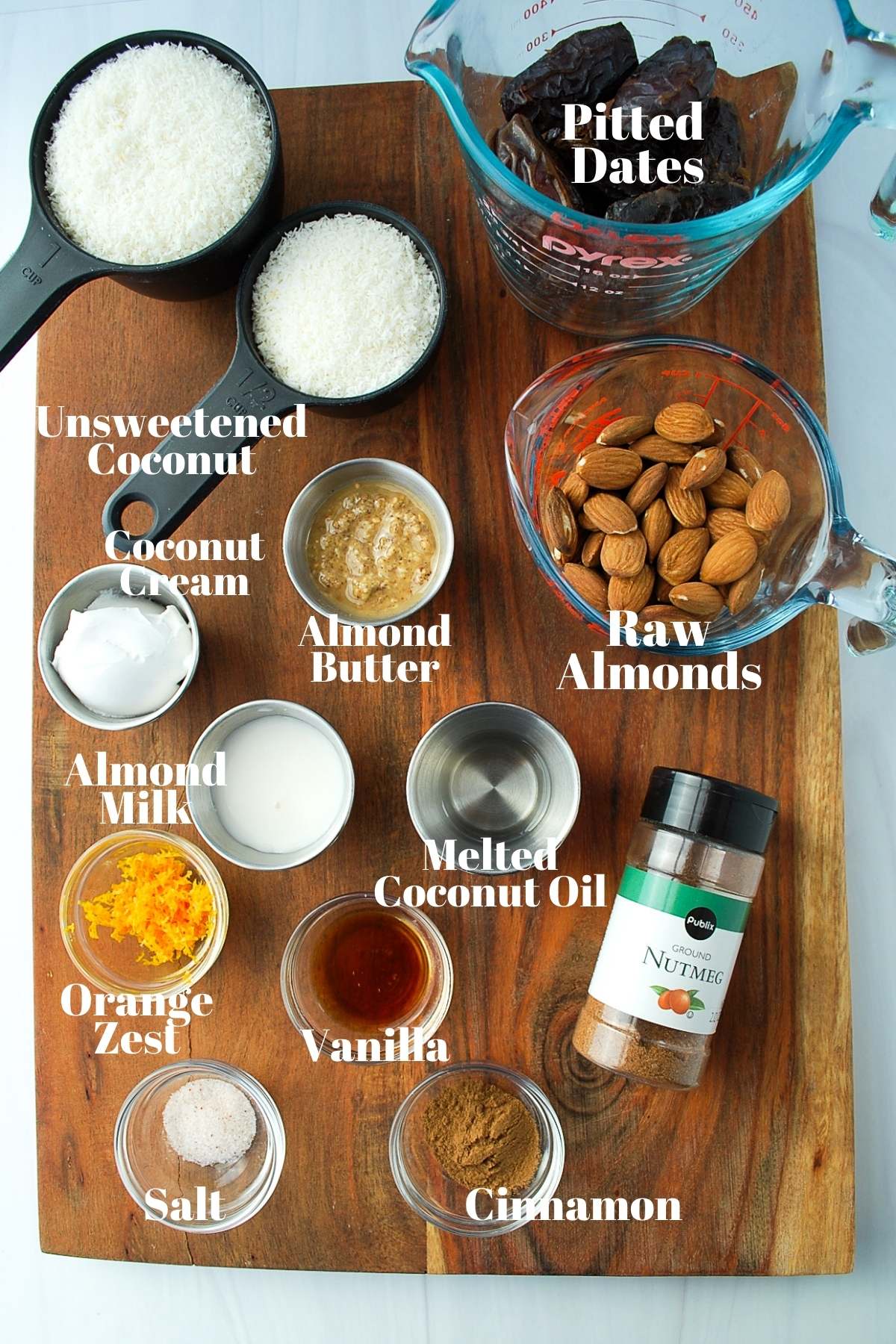 ingredients for almond date balls on a wooden cutting board