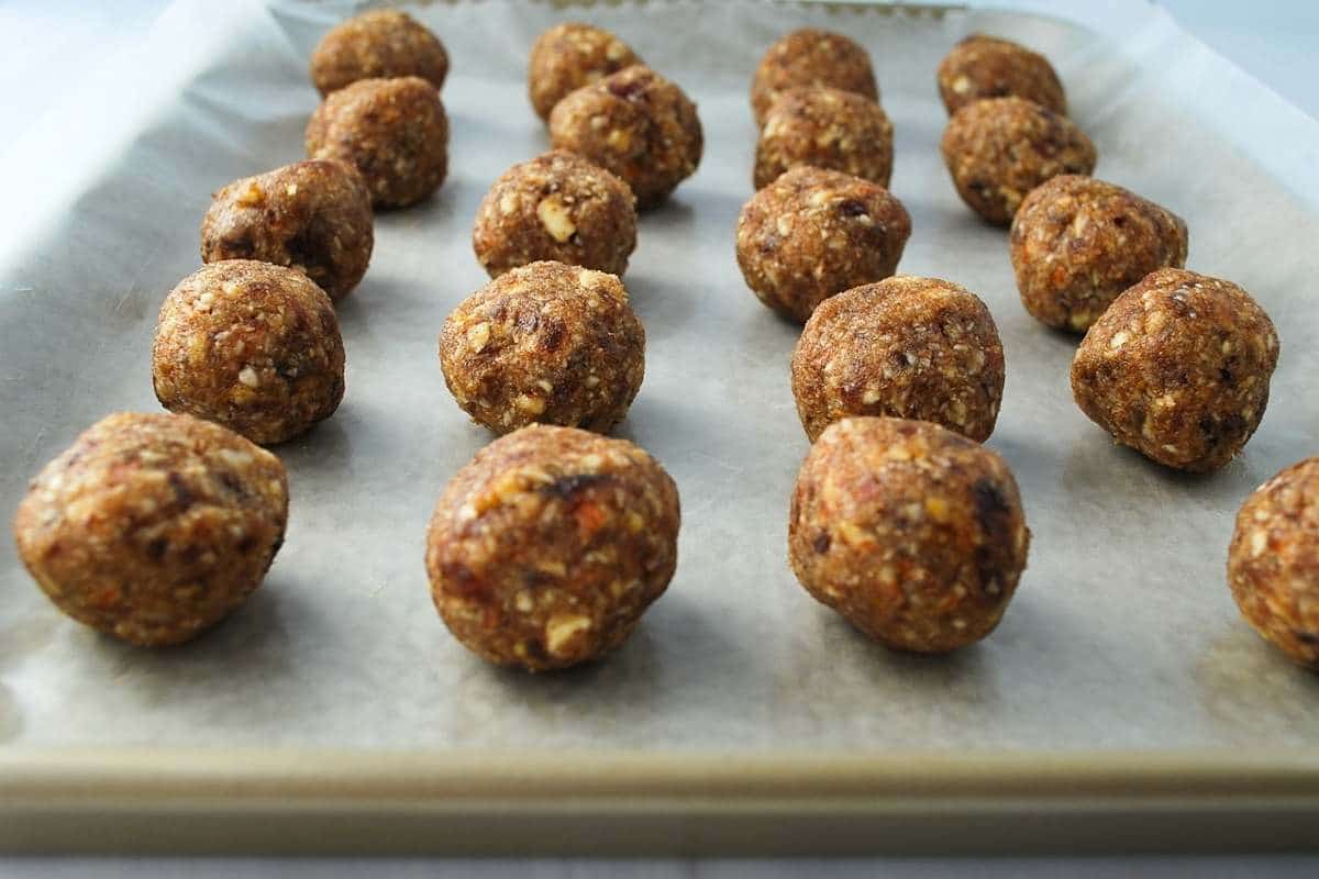 date mixture rolled into 20 balls on a baking sheet