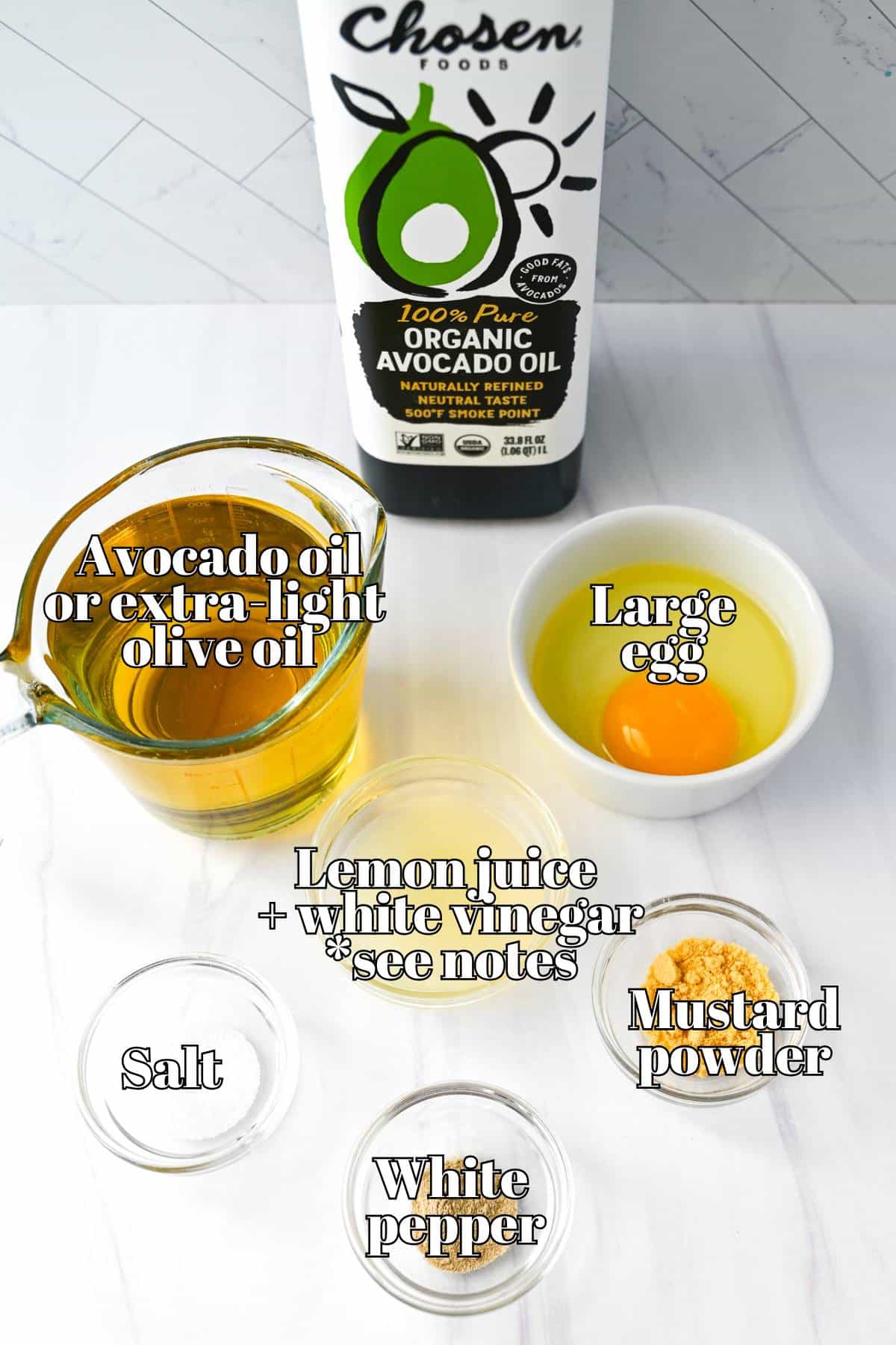 ingredients to make homemade avocado oil mayonnaise measured out on a counter