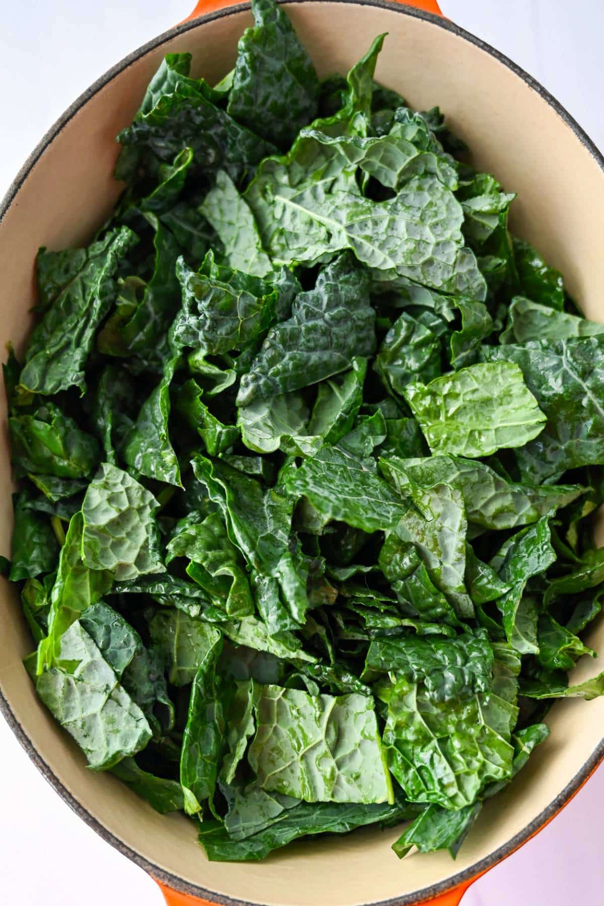 uncooked chopped kale in a dutch oven