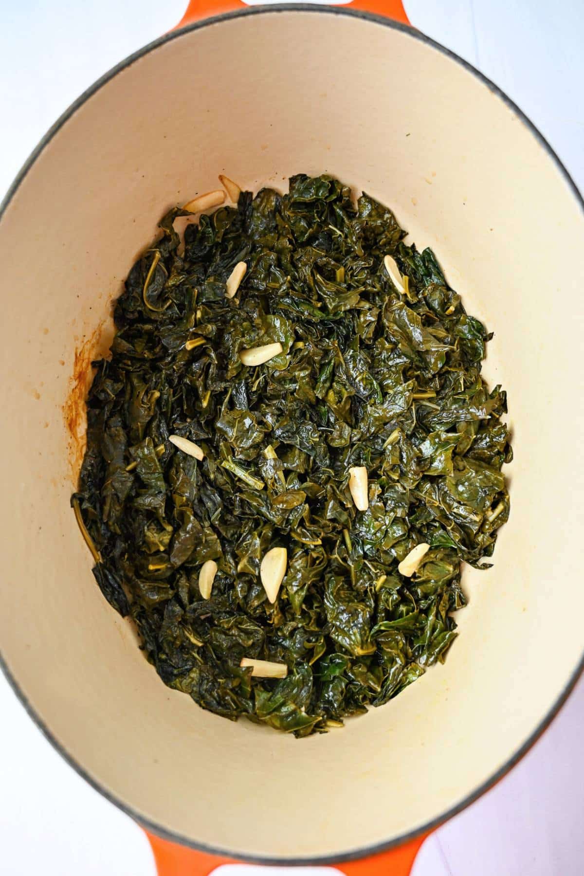 cooked kale and garlic in a dutch oven