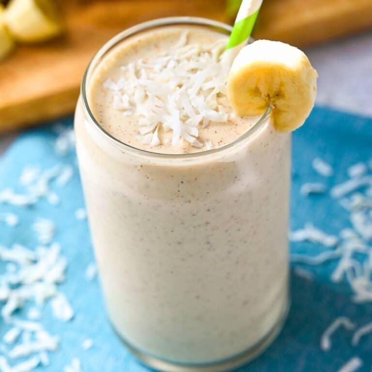 a coconut smoothie with sliced banana and shredded coconut