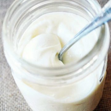 homemade mayonnaise in a mason jar with a spoon