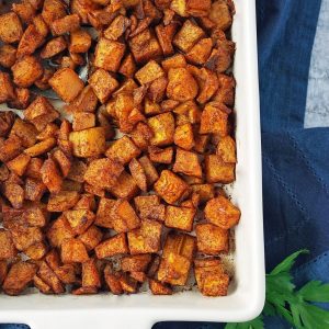 overhead photo of pan of roasted butternut squash with parsley