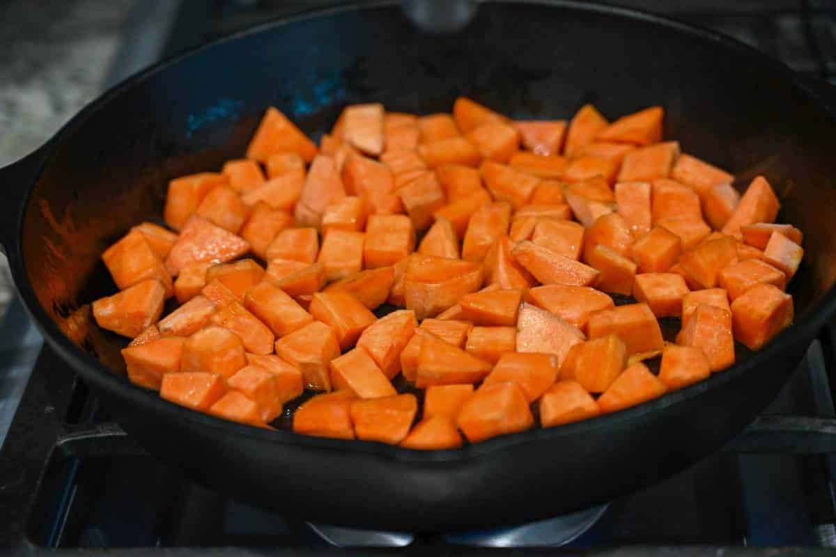 sweet potatoes added to a hot skillet