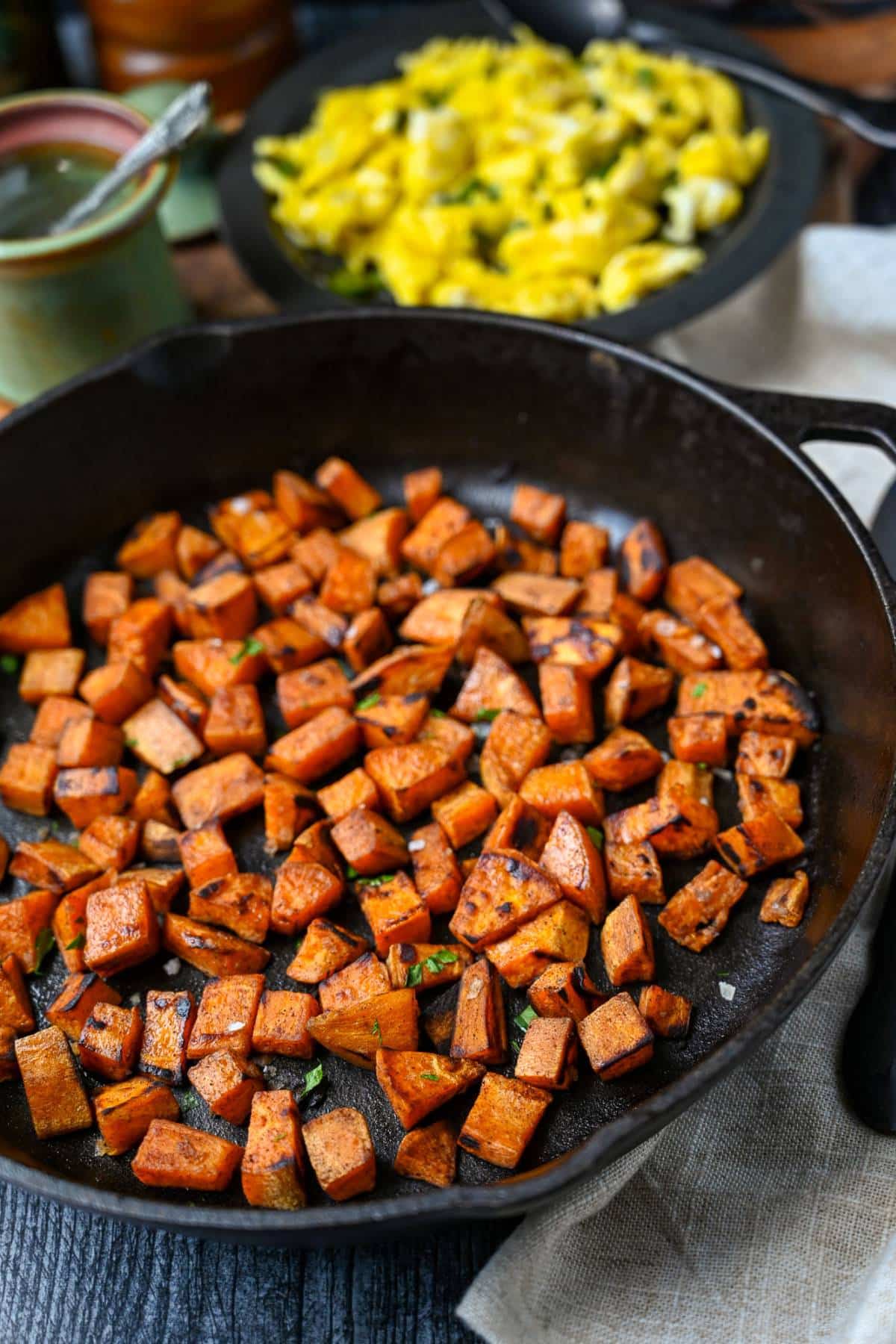 photo of a skillet with fried sweet potatoes and a dish of jalapeno scrambled eggs