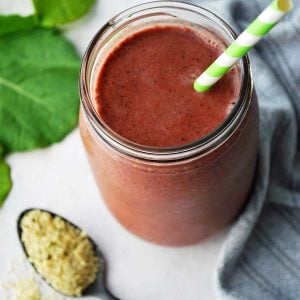 smoothie in a mason jar with green striped straw