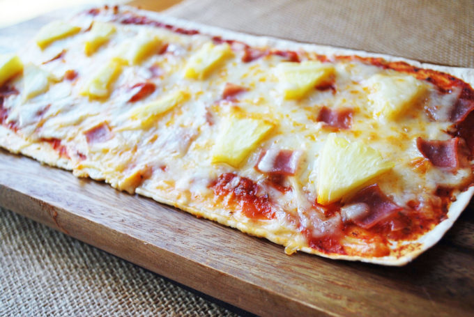 Rustic white flatbread Hawaiian pizza with ham and pineapple