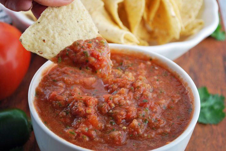 chip being dipped in fresh salsa