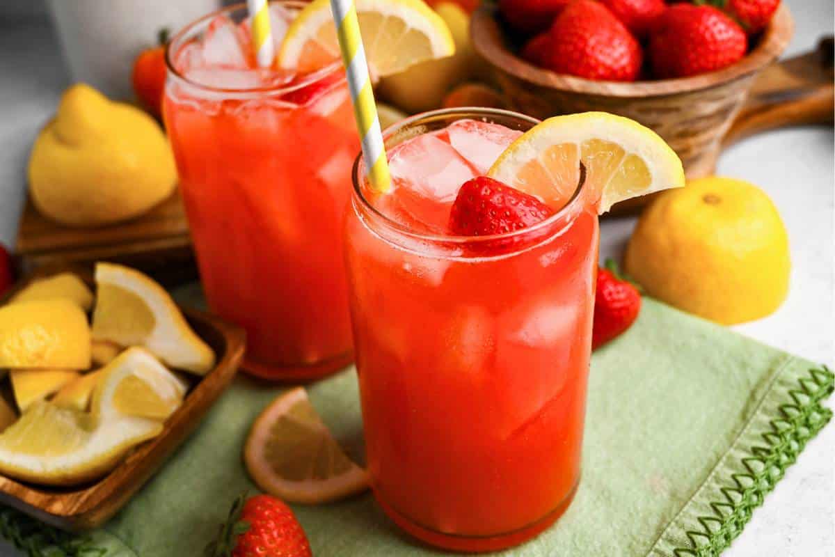 served no sugar added strawberry lemonade with a dish of lemon wedges and a bowl of strawberries