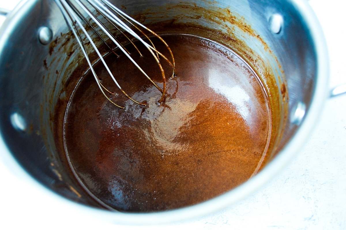 whisking chocolate mixture in a saucepan for no-bake cookies