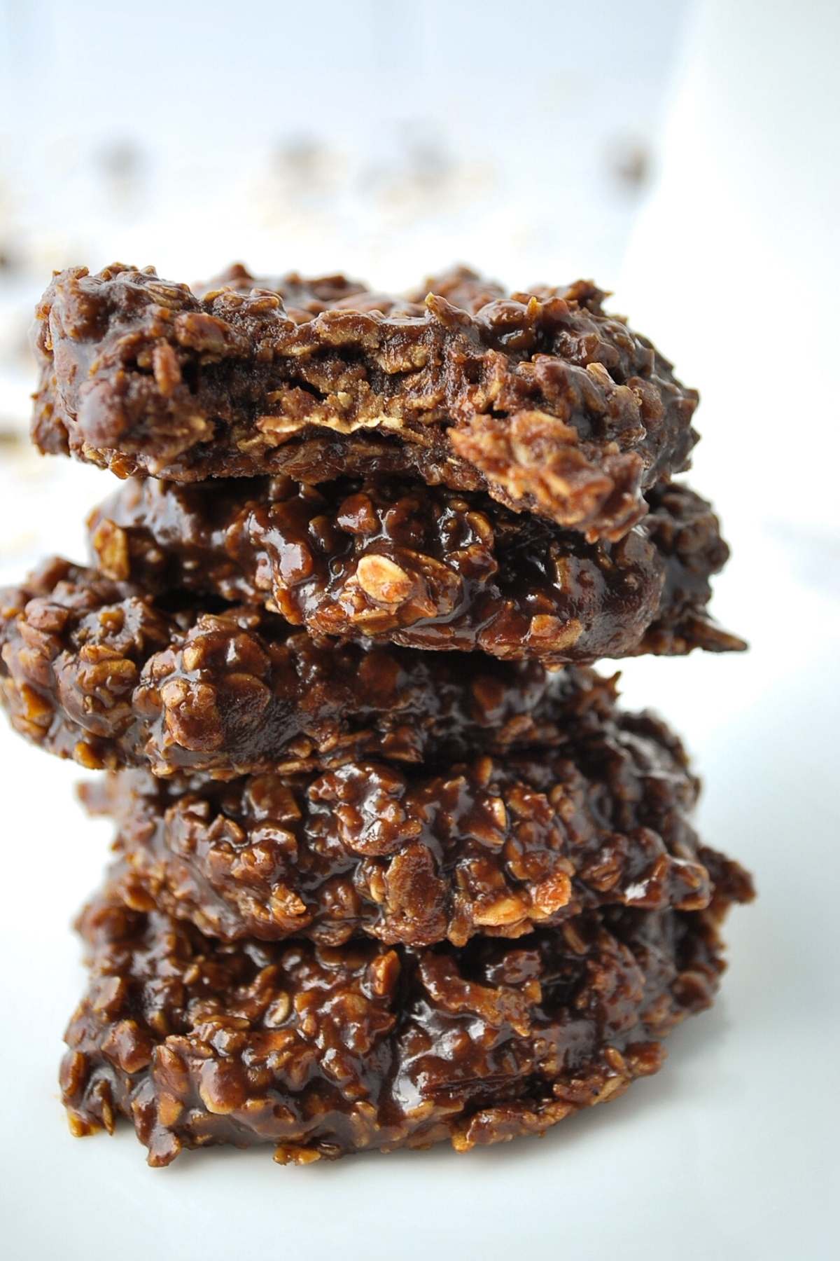 close up of stacked chocolate oatmeal cookies on a plate
