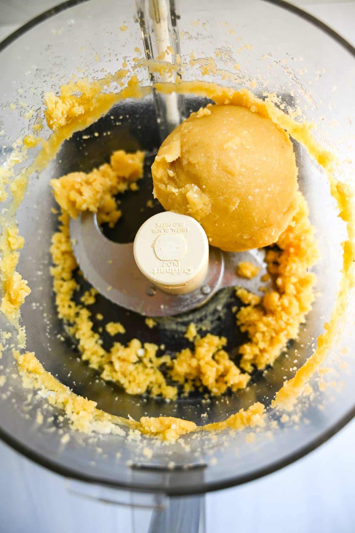 a ball of pie dough in a food processor