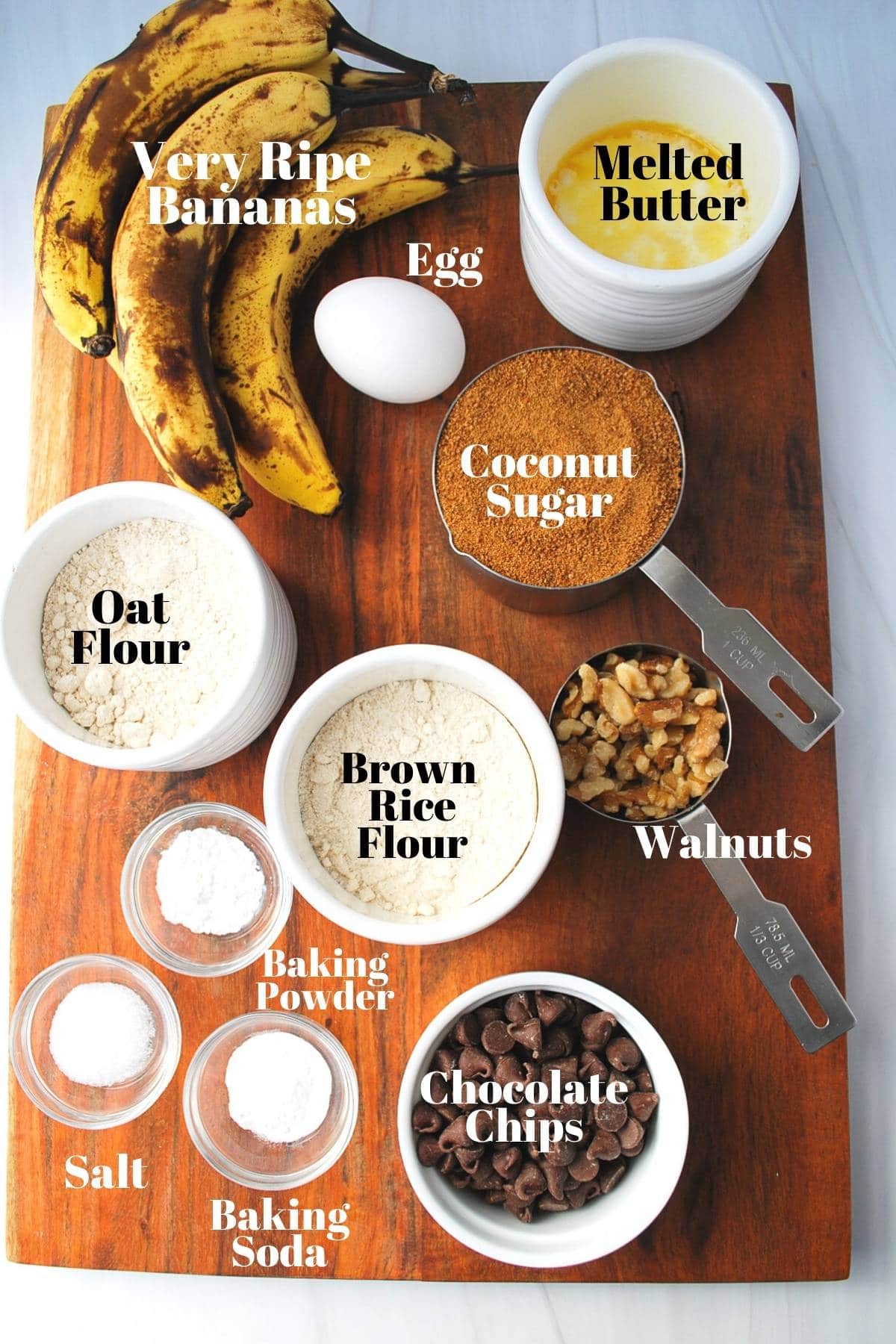ingredients for gluten-free banana bread on a cutting board measured out for baking