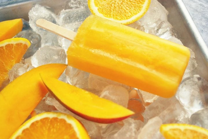 a mango orange popsicle on ice