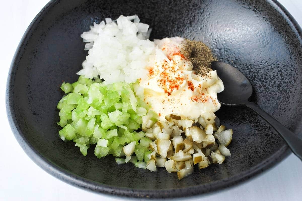 egg salad dressing ingredients in a black bowl