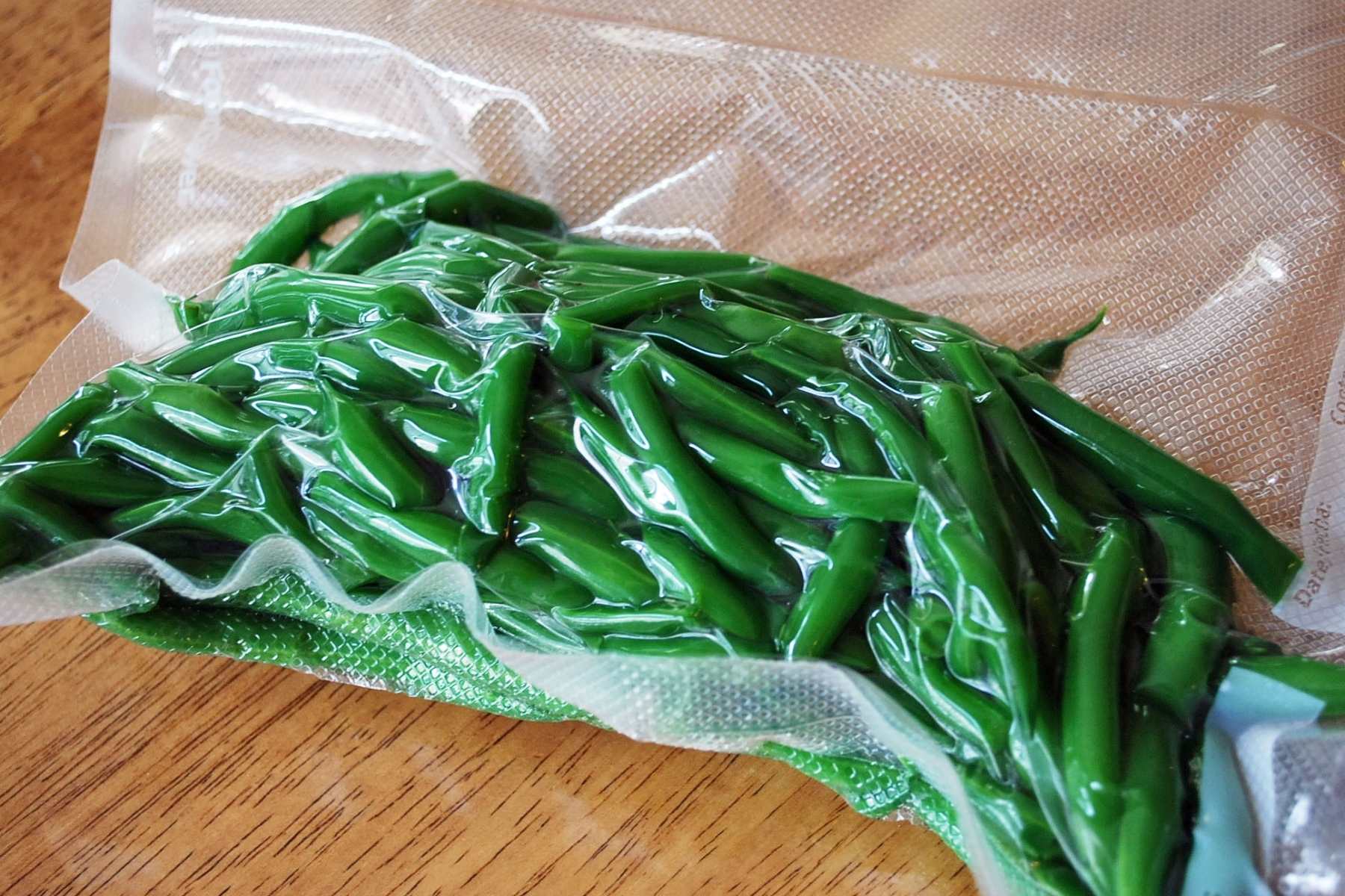 blanched green beans in a sealed bag for freezing