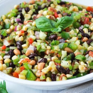 a bowl of healthy carolina caviar with colorful veggies, beans, and fresh herbs.
