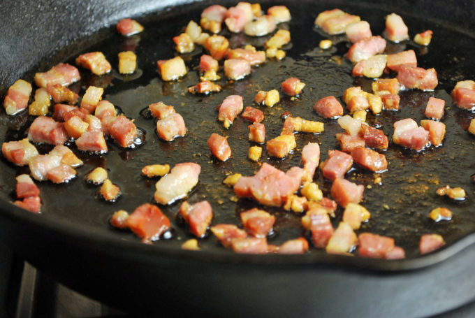 pancetta cooking in a cast iron skillet