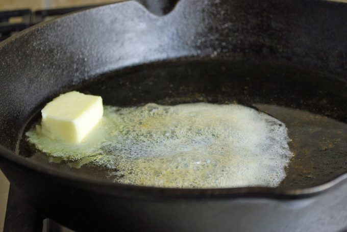 butter melting in a cast iron skillet