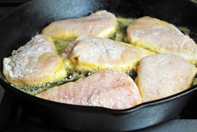 frying chicken breasts in a cast iron skillet