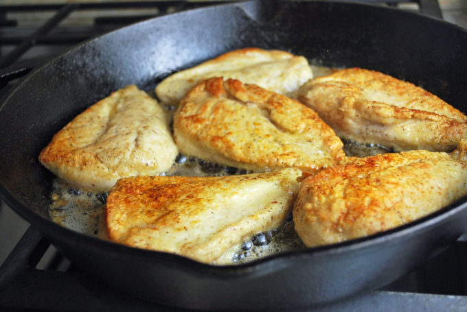 browned chicken breasts in a cast iron skillet