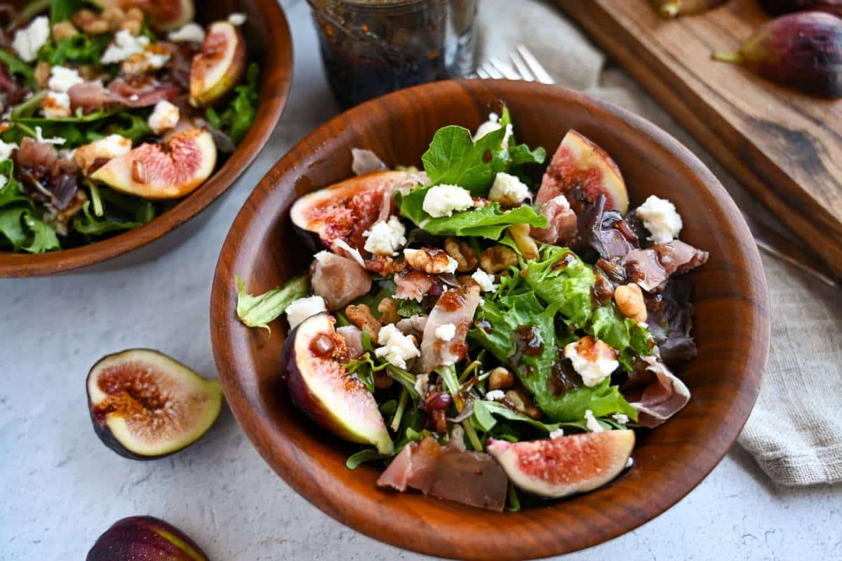 prosciutto salad in a wooden bowl with a fork