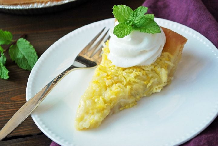 overhead shot of squash pie on a plate with whipped cream and mint