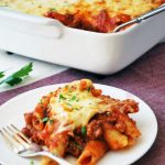 baked mostaccioli on a plate and in a baking dish