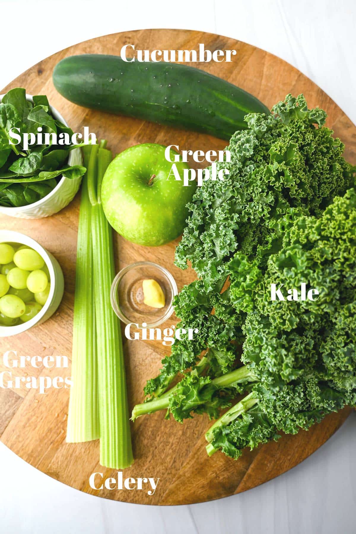 ingredients for green juice on a large cutting board