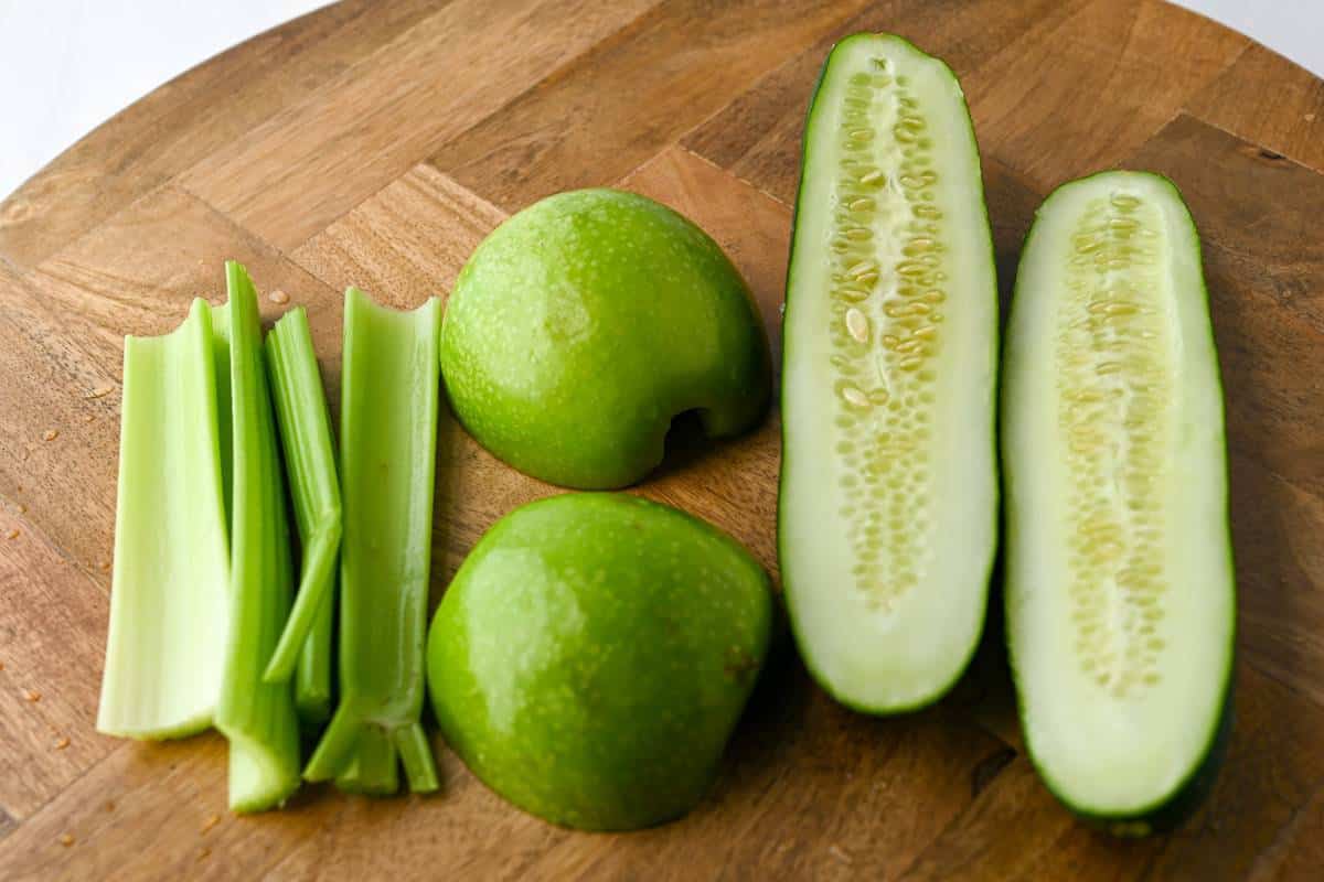 sliced cucumber, lime, and celery on a cutting board