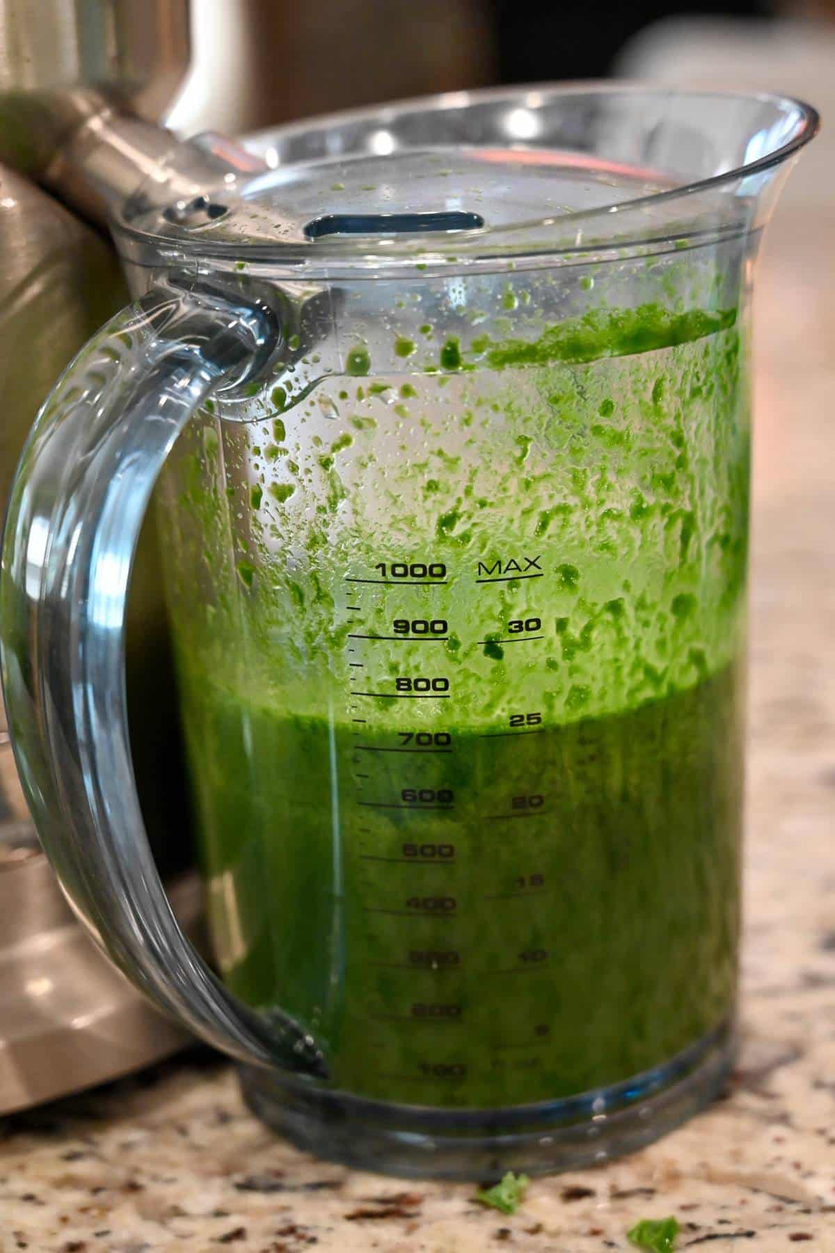 green juice in a juicer container
