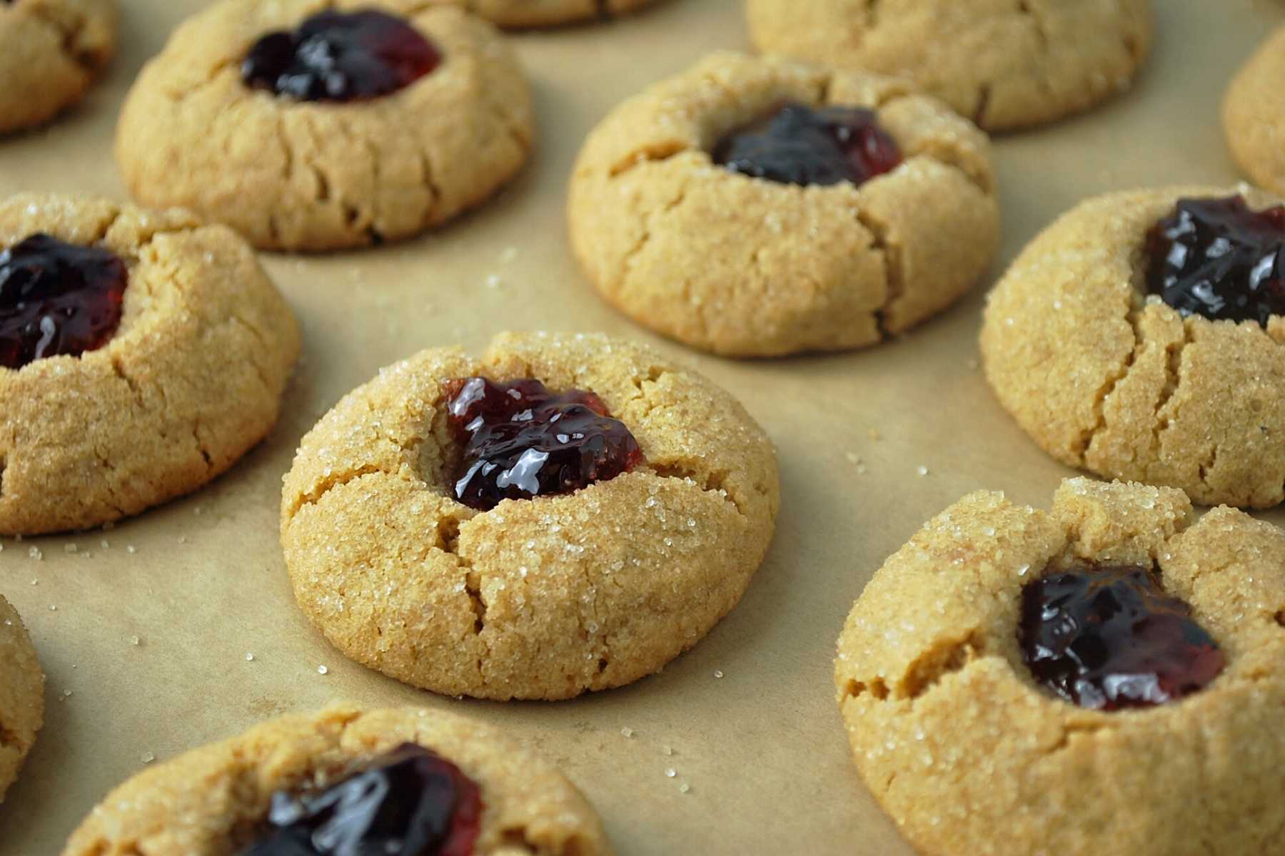jam thumbprint cookies fresh from the oven on a baking sheet