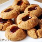 Gluten-free peanut butter and jelly thumbprint cookies are delicious, soft peanut butter cookies with fresh fruit preserves in the center.