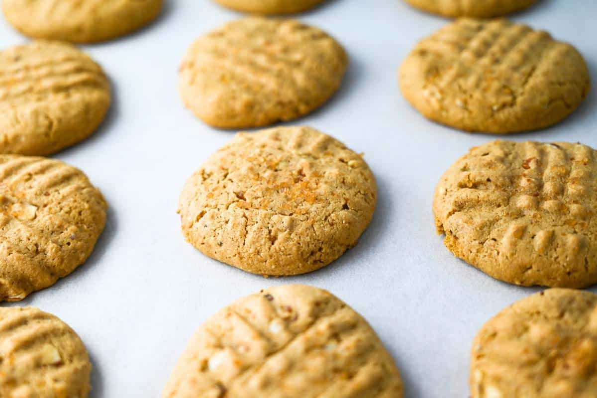 baked cashew cookies on a lined baking sheet
