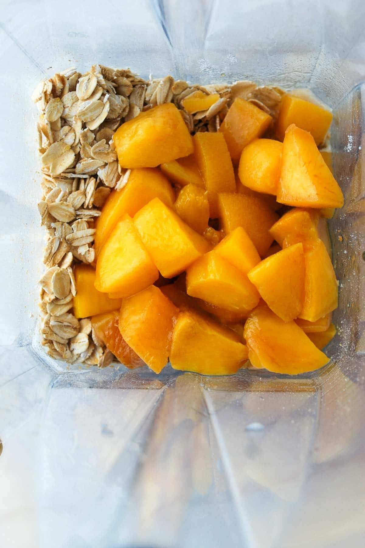 ingredients for peach protein baked oatmeal in a blender ready to blend