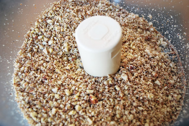Ground nuts made in a food processor for dark chocolate nutty bars