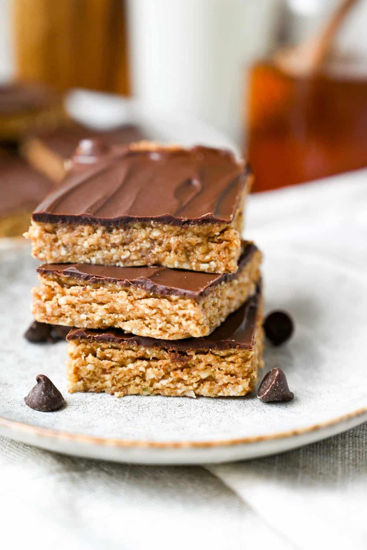 nutty bars frosted with chocolate on a plate with chocolate chips