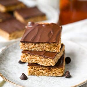 a stack of chocolate covered nut bars with chocolate chips