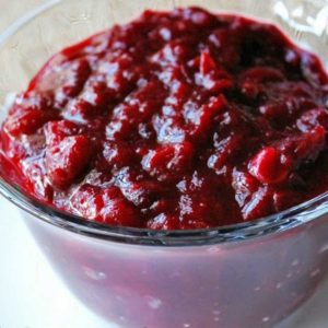 cranberry sauce in a glass bowl with a spoon